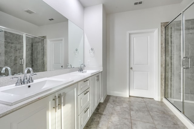 bathroom featuring visible vents, a sink, and tile patterned floors