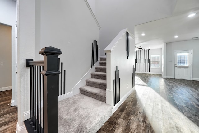 stairs with baseboards, wood finished floors, a ceiling fan, and recessed lighting