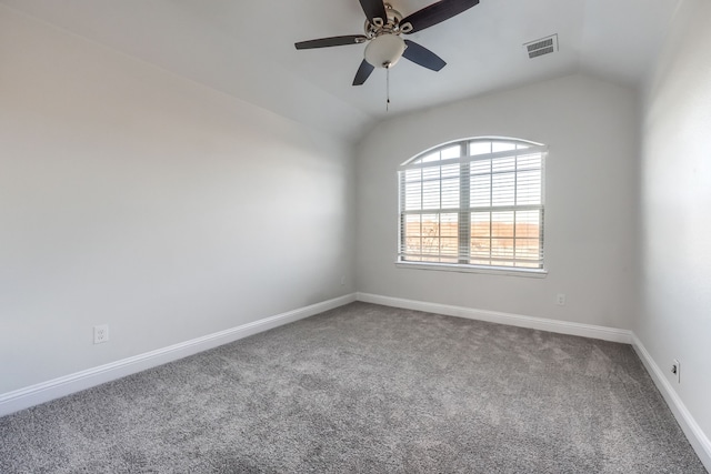 spare room with lofted ceiling, carpet flooring, visible vents, and baseboards