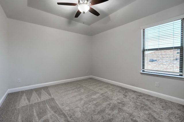 carpeted empty room featuring plenty of natural light, baseboards, and a ceiling fan