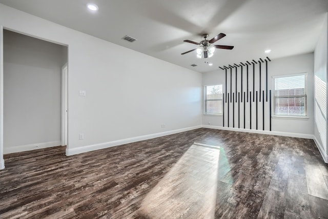 spare room with dark wood-style floors, recessed lighting, visible vents, a ceiling fan, and baseboards