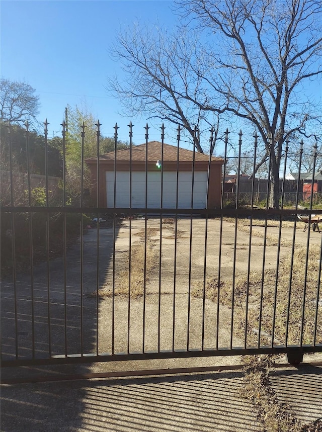 view of gate featuring an outdoor structure and fence