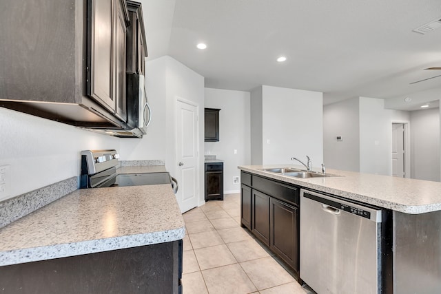 kitchen featuring stainless steel appliances, light countertops, visible vents, a sink, and an island with sink