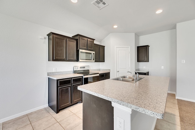 kitchen with a sink, visible vents, light countertops, appliances with stainless steel finishes, and an island with sink