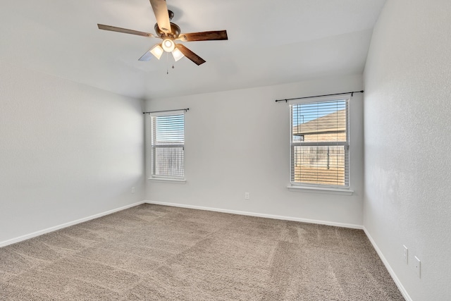 spare room with baseboards, a ceiling fan, and carpet flooring