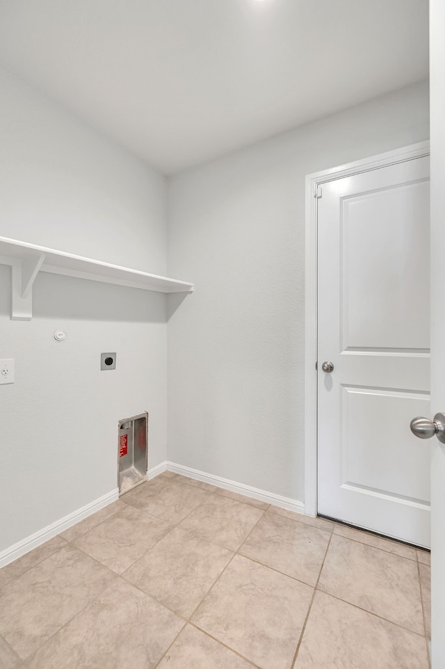 laundry room with light tile patterned floors, hookup for a gas dryer, laundry area, baseboards, and electric dryer hookup