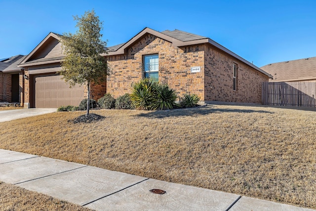 ranch-style house with an attached garage, brick siding, fence, concrete driveway, and a front yard