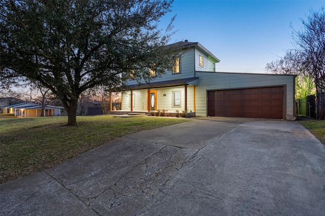 view of front facade with an attached garage, a front lawn, and concrete driveway