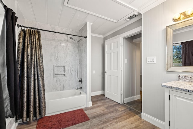 bathroom with shower / tub combo, baseboards, visible vents, wood finished floors, and vanity