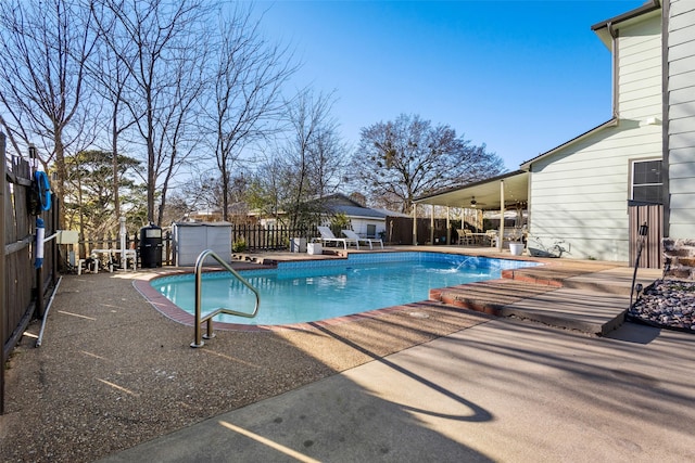 view of pool with a ceiling fan, a patio area, a fenced backyard, and a fenced in pool