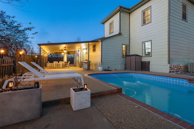 view of swimming pool with a patio area, fence, and a fenced in pool