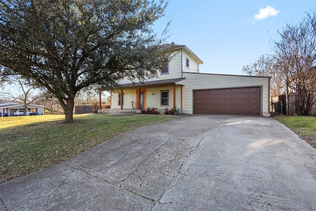 view of front of property featuring a garage, concrete driveway, and a front yard