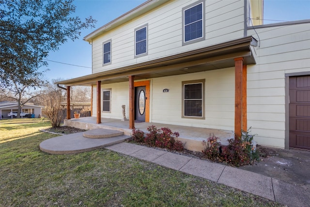 view of front of home featuring covered porch and a front yard