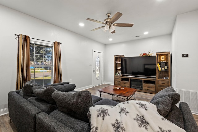 living room featuring ceiling fan, wood finished floors, visible vents, and recessed lighting