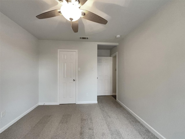 unfurnished bedroom featuring baseboards, visible vents, ceiling fan, and carpet flooring