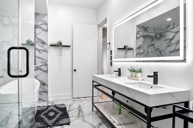 full bathroom with a soaking tub, marble finish floor, a sink, and double vanity