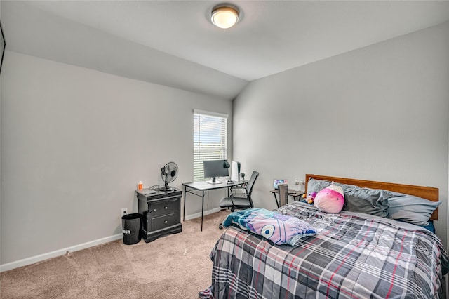 carpeted bedroom featuring lofted ceiling and baseboards