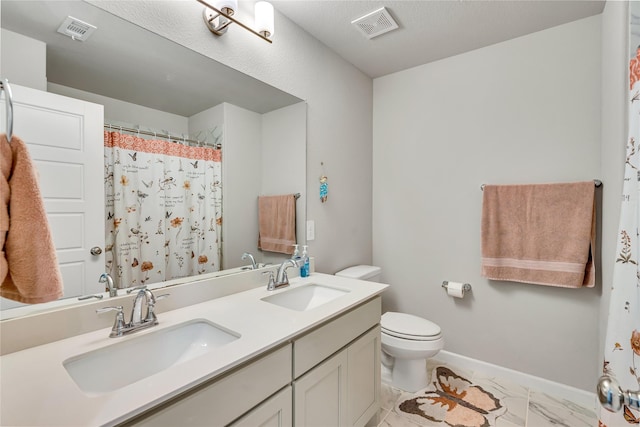 bathroom featuring toilet, visible vents, and a sink