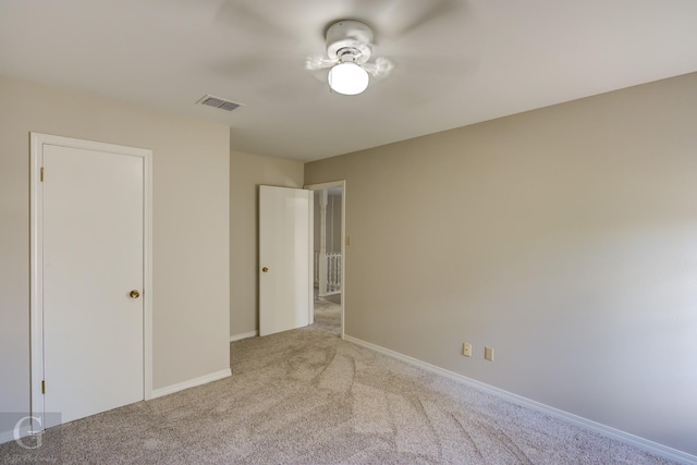 unfurnished bedroom with light carpet, visible vents, and baseboards