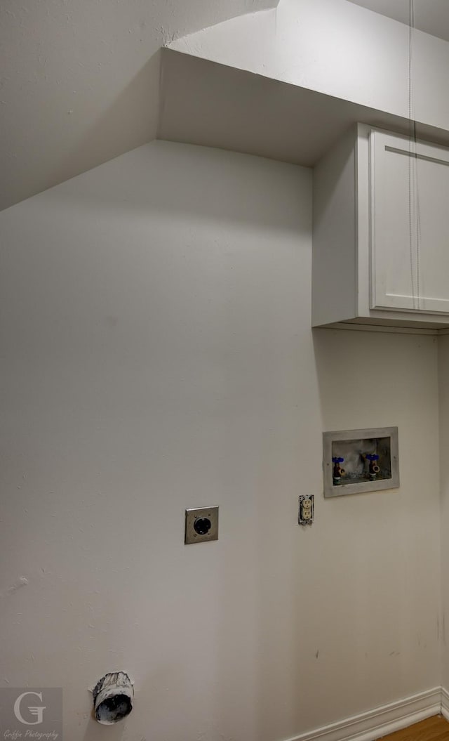 clothes washing area featuring washer hookup, cabinet space, hookup for an electric dryer, and baseboards