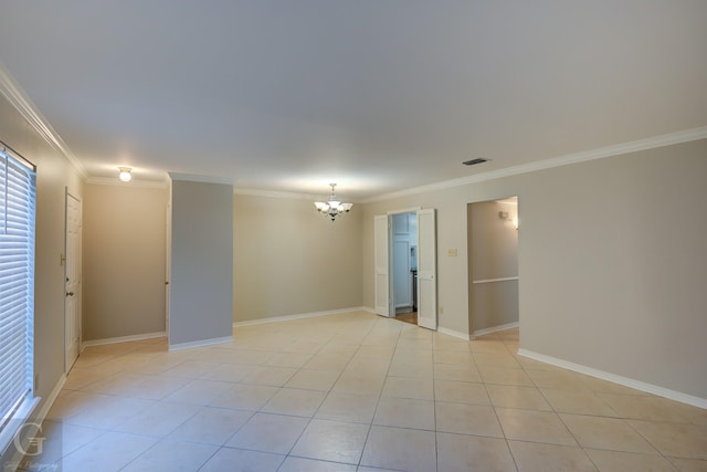 unfurnished room featuring light tile patterned floors, ornamental molding, baseboards, and an inviting chandelier