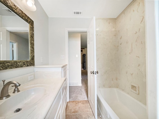 bathroom with vanity, a bathing tub, visible vents, and tile patterned floors