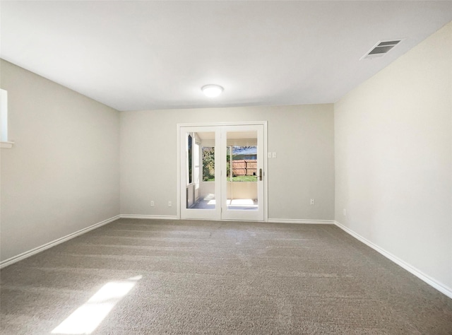 carpeted empty room with visible vents and baseboards