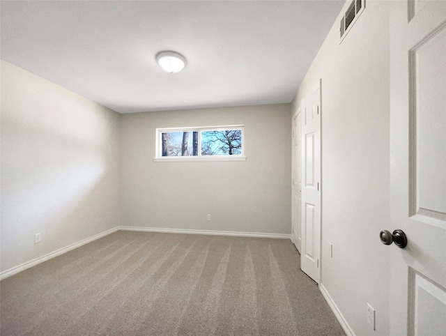 unfurnished bedroom with carpet, visible vents, and baseboards