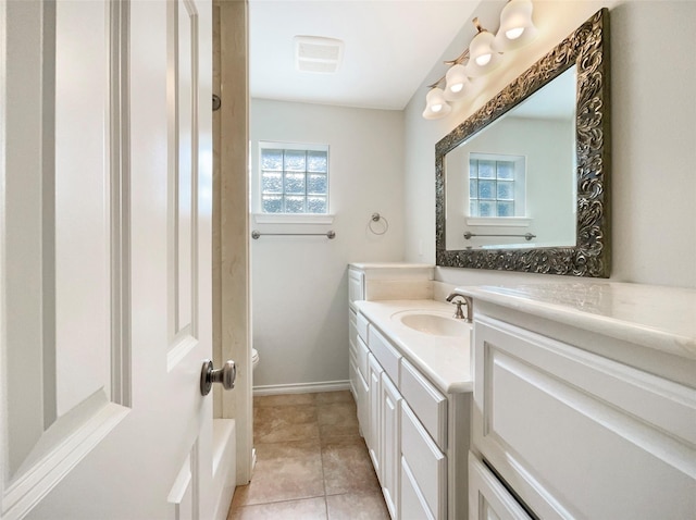 bathroom with baseboards, toilet, vanity, and tile patterned floors