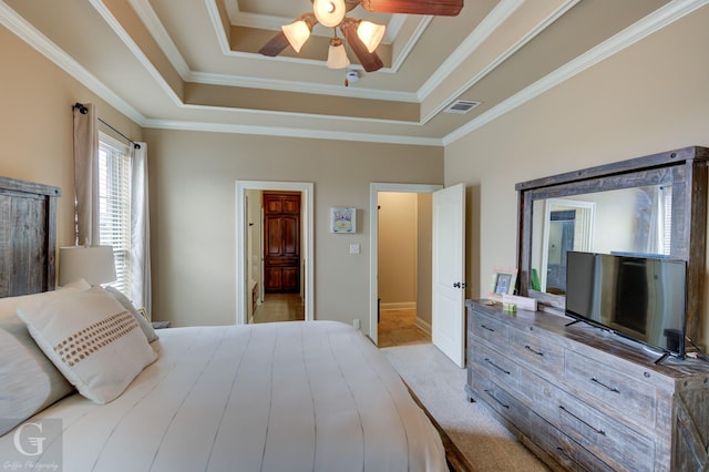 bedroom with light carpet, visible vents, a ceiling fan, ornamental molding, and a tray ceiling