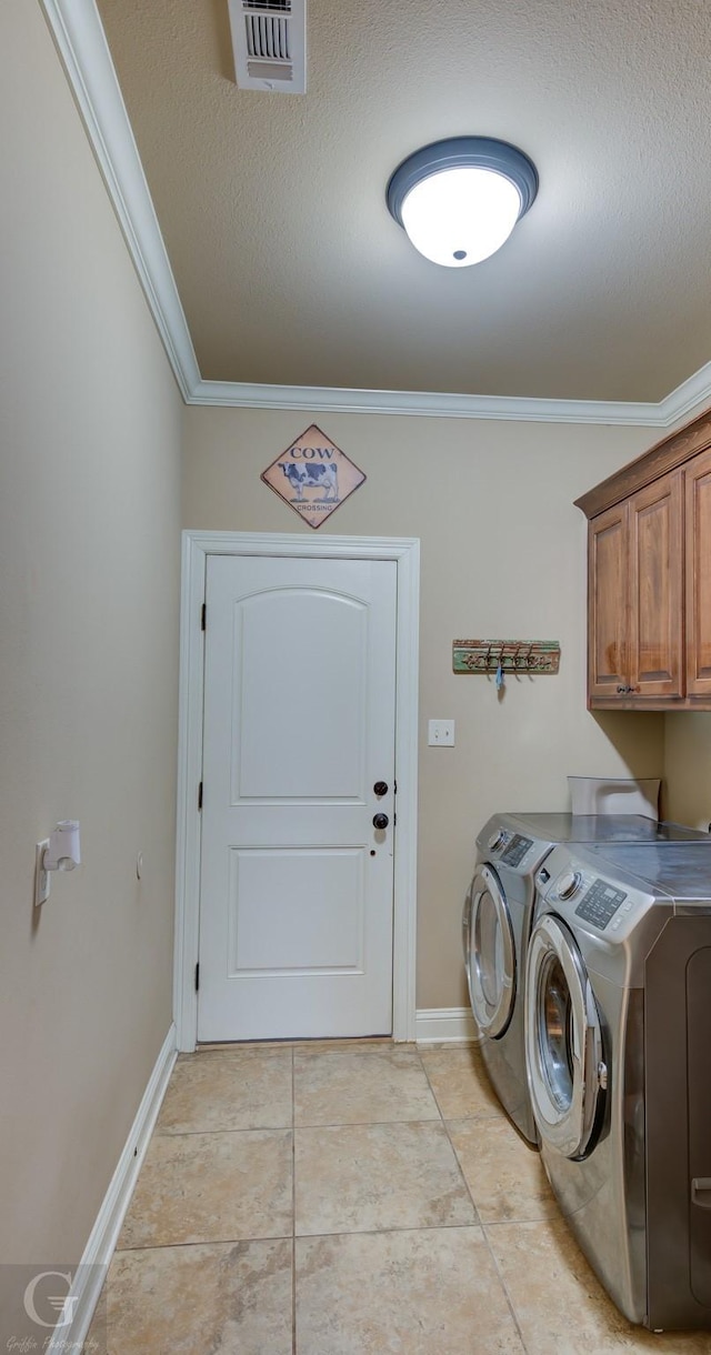 washroom with crown molding, washer and clothes dryer, visible vents, cabinet space, and a textured ceiling