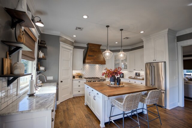 1188 An County Road 103, Elkhart, TX 75839 - kitchen featuring high quality fridge, wood counters, custom exhaust hood, a sink, and white cabinets