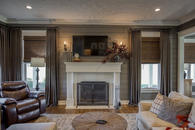 1188 An County Road 103, Elkhart, TX 75839 - living area featuring crown molding, wood finished floors, a fireplace, recessed lighting, and plenty of natural light