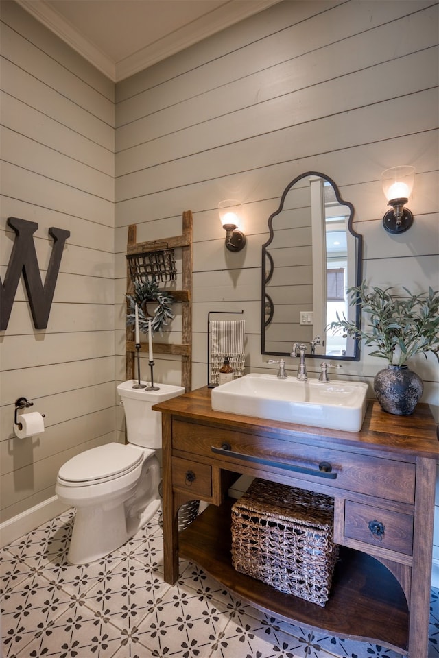 1188 An County Road 103, Elkhart, TX 75839 - bathroom with toilet, wooden walls, ornamental molding, vanity, and tile patterned floors