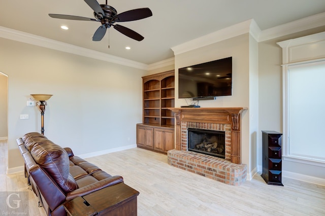 living room with a brick fireplace, light wood-style flooring, and crown molding