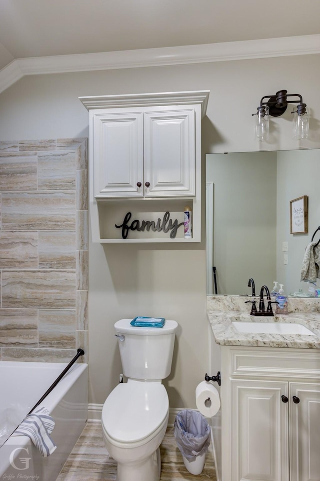 full bath featuring toilet, wood finished floors, bathing tub / shower combination, vanity, and crown molding