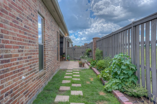 view of yard with a patio area and a fenced backyard