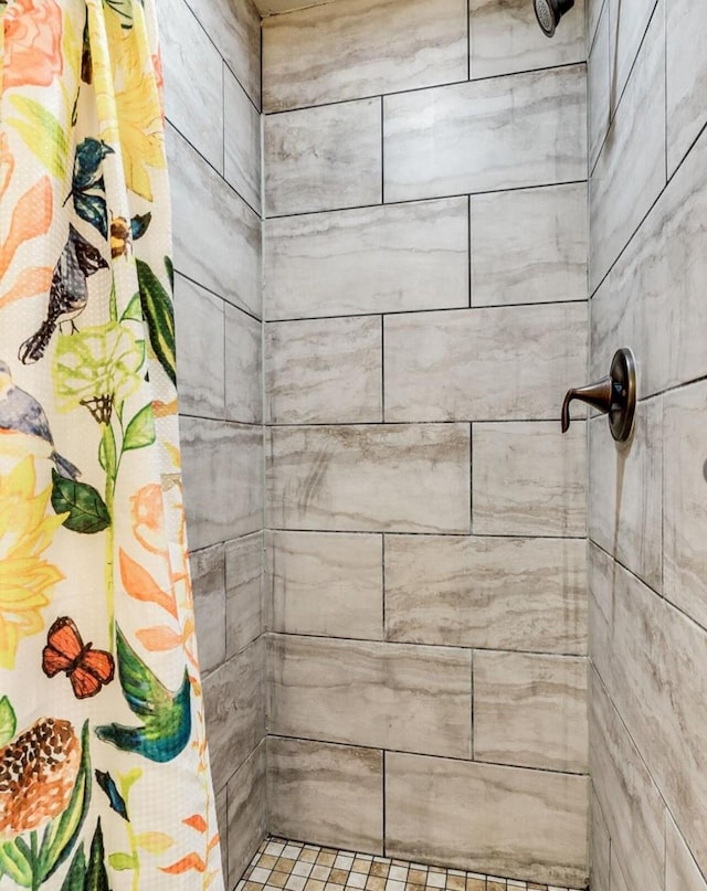 full bath with a tile shower