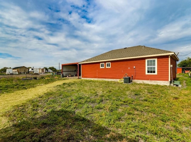 back of house with a yard and cooling unit