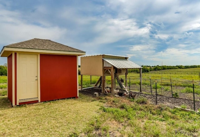 view of outdoor structure featuring an outbuilding and a rural view