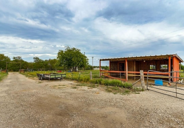 view of stable featuring a rural view