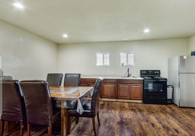 dining space featuring dark wood finished floors and recessed lighting