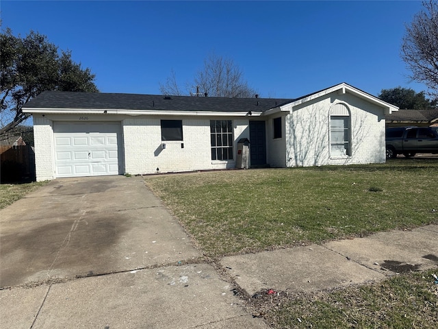 single story home with an attached garage, a front lawn, concrete driveway, and brick siding