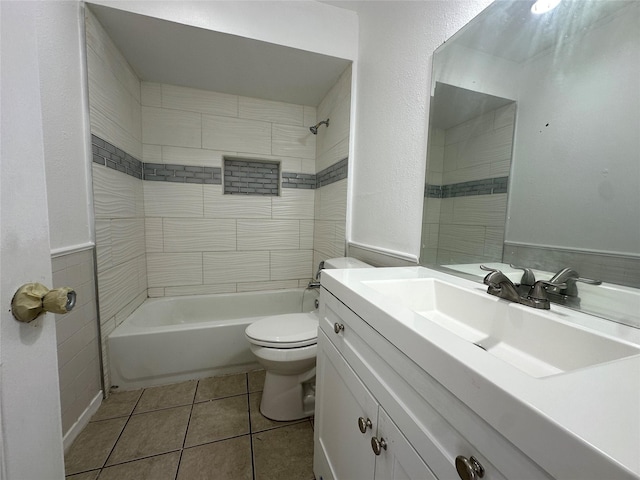 full bathroom with toilet, a wainscoted wall, tile patterned floors, tub / shower combination, and vanity