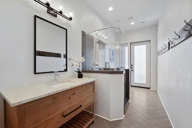 bathroom featuring a stall shower, recessed lighting, visible vents, and vanity