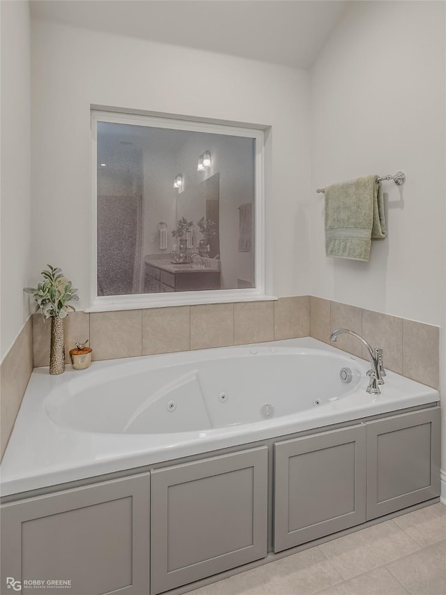 bathroom featuring tile patterned flooring and a tub with jets