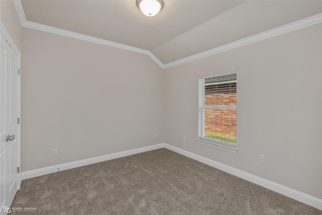 carpeted spare room with vaulted ceiling, ornamental molding, and baseboards