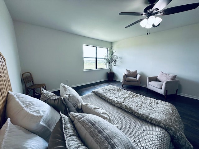 living room with dark wood-style floors, baseboards, and a ceiling fan
