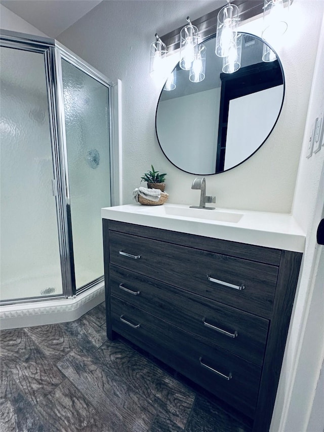 full bathroom featuring a stall shower and vanity