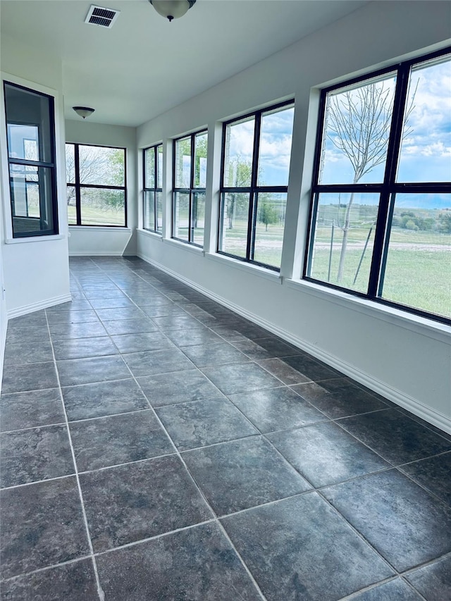 unfurnished sunroom featuring visible vents
